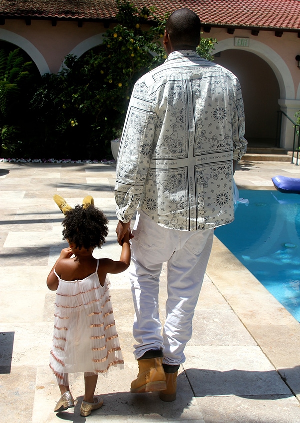 Blue holding her dad’s hands