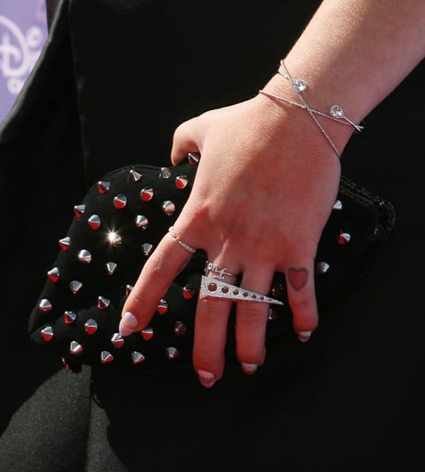 Kelly Osbourne showcases her studded clutch and statement rings at the 2014 Disney Music Awards