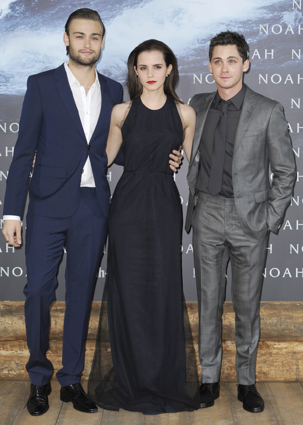 Logan Lerman (5ft 7½ or 171.5 cm), Douglas Booth (6ft or 182.9 cm), and Emma Watson (5ft 4¾ or 164.5 cm) pose together at a Noah promo event, highlighting their noticeable height differences in sleek formalwear