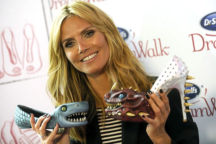 Heidi Klum holding up the Shoe Meanies from her Dr. Scholl's DreamWalk commercial