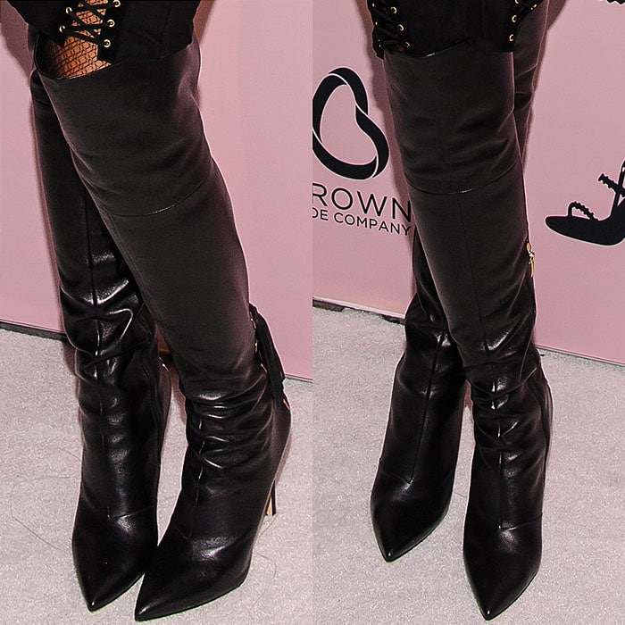 Jennifer Hudson showcased the dramatic silhouette of her black leather Via Spiga “Femke” over-the-knee boots, featuring pointed toes, slim heels, and lace-up detailing that echoed the edgy design of her outfit