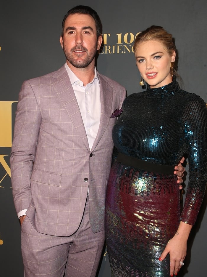 At the Maxim Hot 100 Experience, a then-pregnant Kate Upton shimmered in a long-sleeve sequined bodycon dress in iridescent jewel tones, while husband Justin Verlander looked dapper in a mauve plaid suit paired with a crisp white shirt and no tie