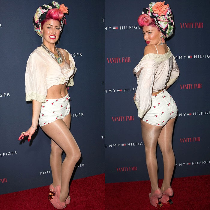 Neon Hitch makes a bold statement in a floral headwrap, vintage-inspired blouse, and cherry-printed high-waisted shorts paired with quirky pink platform heels at the "To Tommy, From Zooey" collection launch