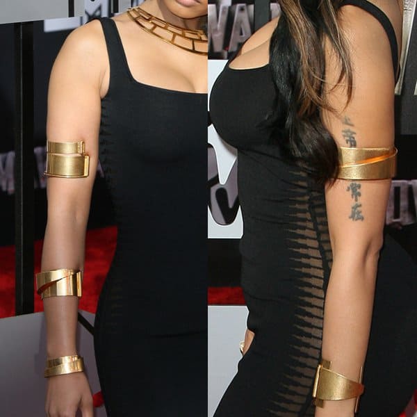 Nicki Minaj's bold gold arm cuffs add a striking touch to her sophisticated look at the 2014 MTV Movie Awards