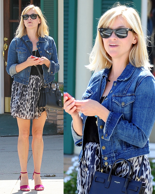 Reese Witherspoon elevated her off-duty look with a Saint Laurent Baby Sac De Jour tote, Joie “Jaclyn” suede ankle-strap sandals, Ray-Ban 2132 New Wayfarer sunglasses, and a Current/Elliott Snap denim jacket, blending high-fashion staples with relaxed street style