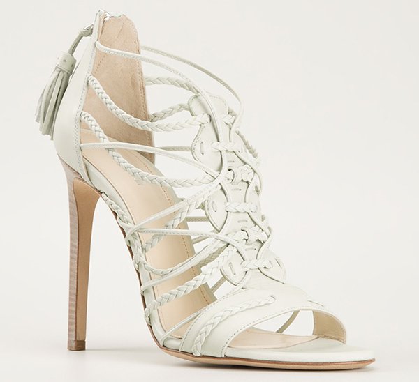 This angled product shot highlights the Roberto Cavalli braided leather sandal’s sculptural crossover straps, tassel-zip back, and sleek stacked stiletto heel
