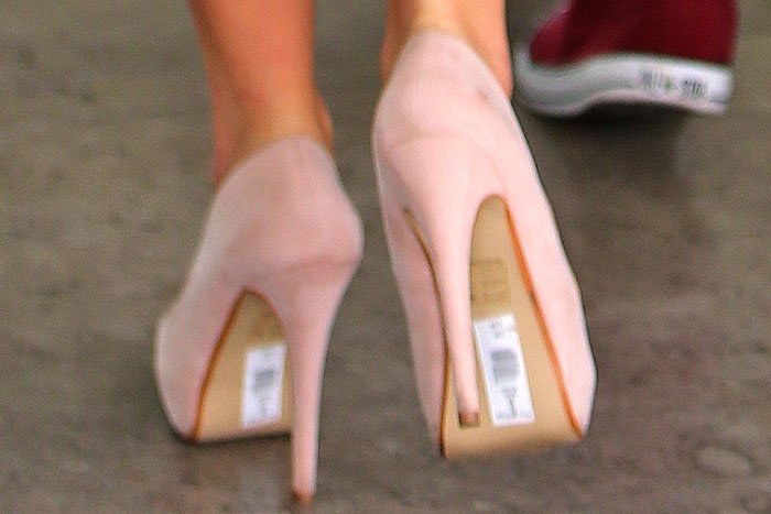 Tulisa Contostavlos with a sticker label her on shoes
