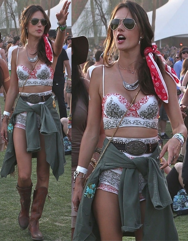 Alessandra Ambrosio showcases her boho-chic flair in a printed bustier and matching shorts from her ále by Alessandra line, styled with layered jewelry, a red bandana, and worn-in brown cowboy boots