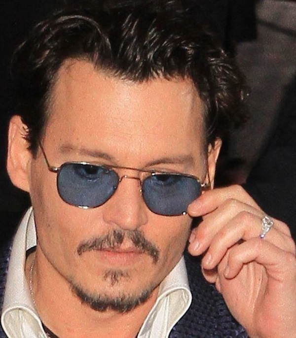 Johnny Depp added his signature edge to the Tom Ford suit with sleek blue-tinted aviator sunglasses