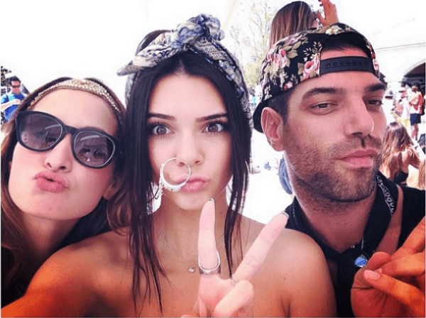 Showing off her signature festival flair, Kendall Jenner poses with friends wearing a paisley headband and statement nose ring for a bohemian twist