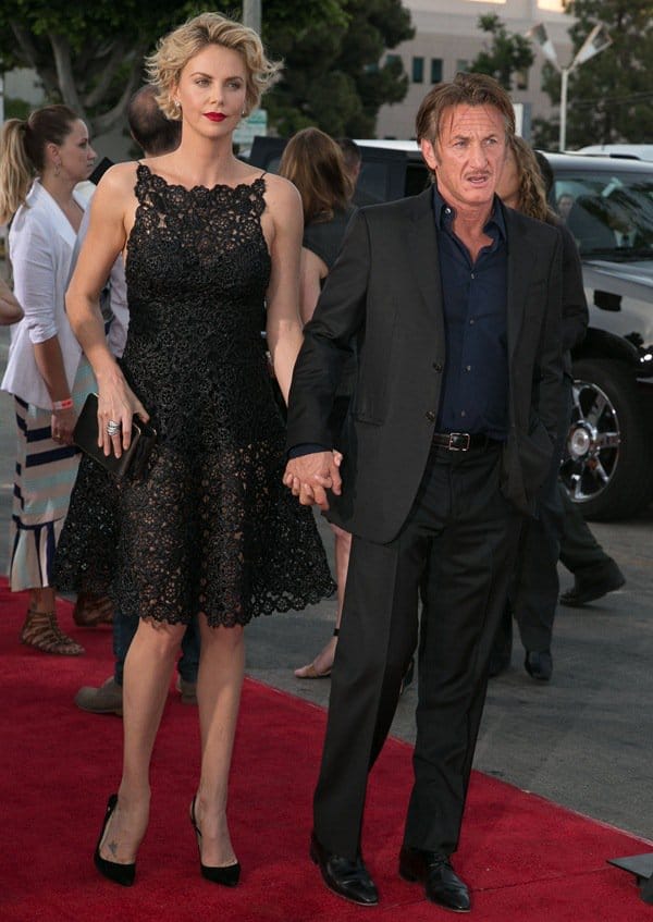 Charlize Theron, towering over Sean Penn in her black Dior raffia dress and sky-high heels, stood hand-in-hand with her boyfriend, who kept it classic in a navy shirt, dark suit, and black leather shoes at the A Million Ways to Die in the West premiere in Los Angeles on May 15, 2014