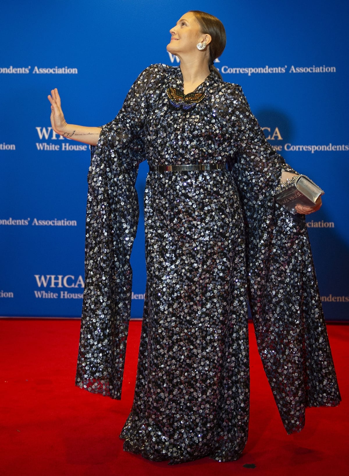Drew Barrymore in a sequined Lanvin cape dress at the 2022 White House Correspondents’ Association Dinner at the Washington Hilton on April 30, 2022, in Washington, DC — her floor-grazing gown obscured the high heels she wore underneath