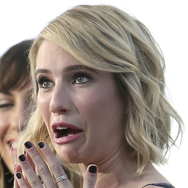 Emma Roberts flaunts a chic blonde bob, glossy black manicure, and an exaggerated expression