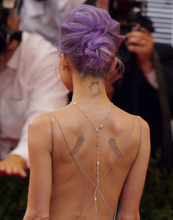 Nicole Richie reveals her delicate angel wings and neck tattoo, elegantly complemented by her backless gown and lavender updo