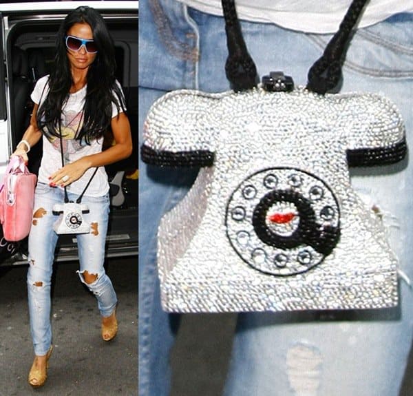 Katie Price adds sparkle to her casual ripped jeans and tee combo with a glittering telephone-shaped handbag, turning a vintage silhouette into a blingy fashion statement while out in London