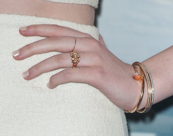 Elle Fanning's rose-themed jewelry to accent her all-white look (Perhaps a shout-out to Princess Aurora? Rose is the nickname of Princess Aurora in Disney's Sleeping Beauty)