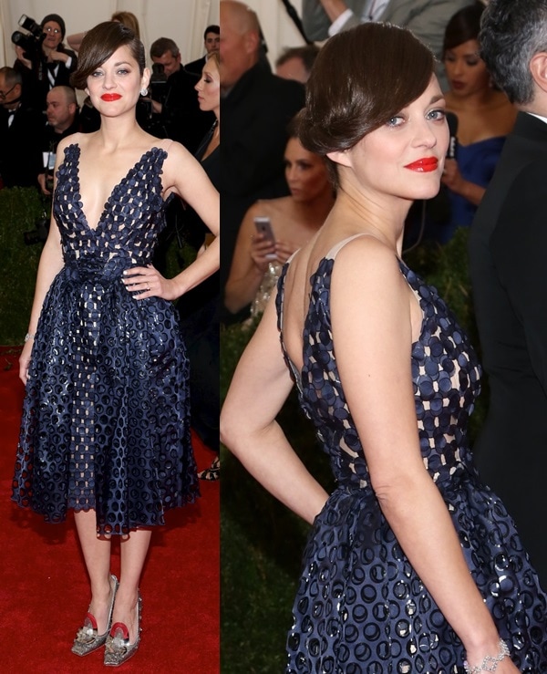 Marion Cotillard turned heads in a navy Christian Dior Haute Couture dress with a geometric cutout overlay, pairing the sculptural silhouette with silver retro-futuristic heels and a sleek chignon