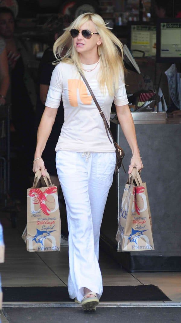 Anna Faris looks effortlessly chic in white wide-legged trousers during a casual day out