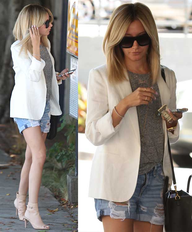 Ashley Tisdale elevates her petite 5ft 2½ (158.8 cm) frame in nude Gianvito Rossi sandal booties, pairing them with distressed Rag Bone denim shorts, a gray top, and a crisp white blazer for a chic summer look