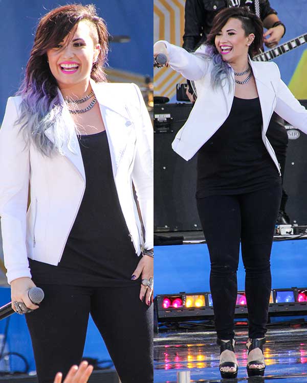 Demi Lovato nails monochrome chic by pairing a crisp white biker jacket with a black tank top, skinny jeans, and platform sandals—perfect for bold, stage-ready style
