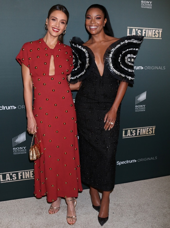 Jessica Alba paired her embellished burgundy Proenza Schouler gown with delicate metallic sandals, while Gabrielle Union balanced the premiere’s dramatic fashion energy in a sculptural black-and-white Nguyen Cong Tri design with oversized statement sleeves