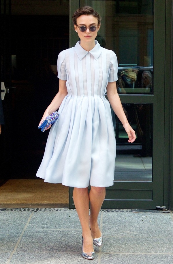 Keira Knightley demonstrates timeless elegance in a structured pastel dress, metallic pumps, and a statement clutch, perfect for a chic day look
