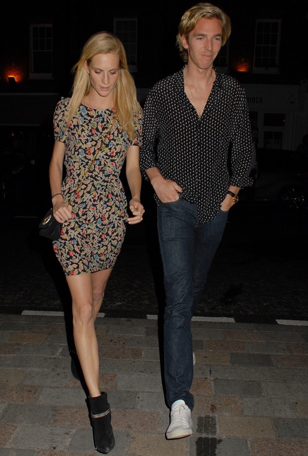 Fashionable date night: Poppy Delevingne in a floral dress paired with Saint Laurent boots alongside James Cook