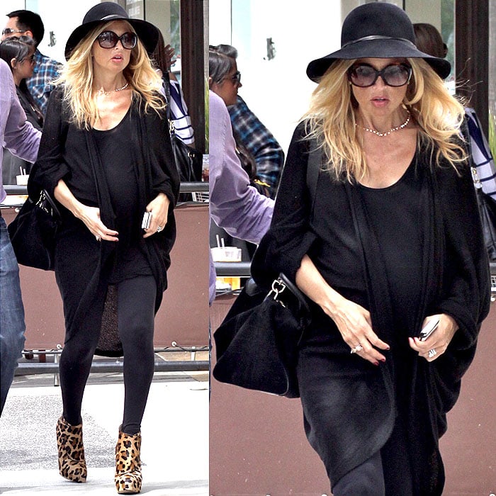 At 38 weeks pregnant, Rachel Zoe stepped out in Beverly Hills on March 14, 2011, exuding her signature chic style in an all-black ensemble, including leggings, a flowing cardigan, a floppy hat, oversized sunglasses, and leopard-print platform booties