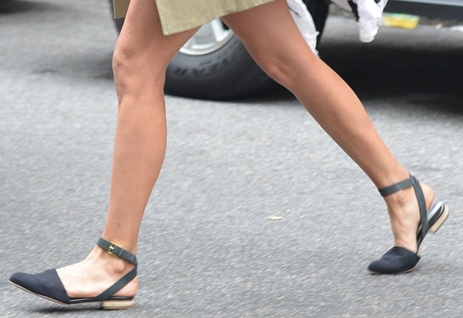 In motion, Nina Dobrev’s slingback flats highlight a low-profile sole and structured vamp that elongate the foot while keeping the look practical for city walking