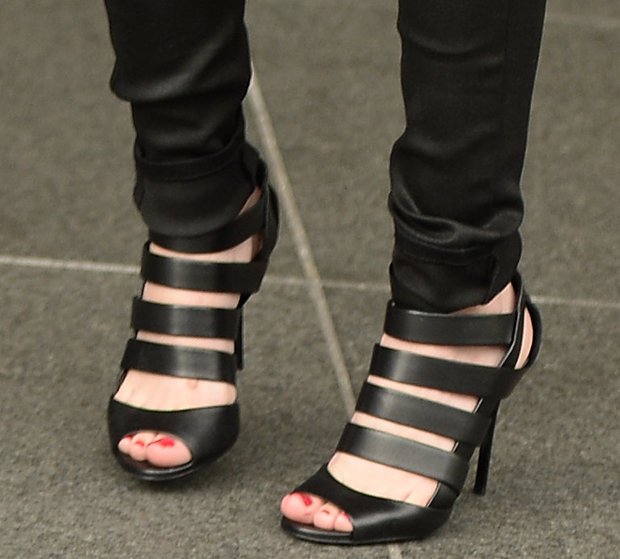Cher Lloyd’s strappy black Jimmy Choo “Damsen” sandal booties added a bold, sculptural finish to her sleek blue-and-black ensemble