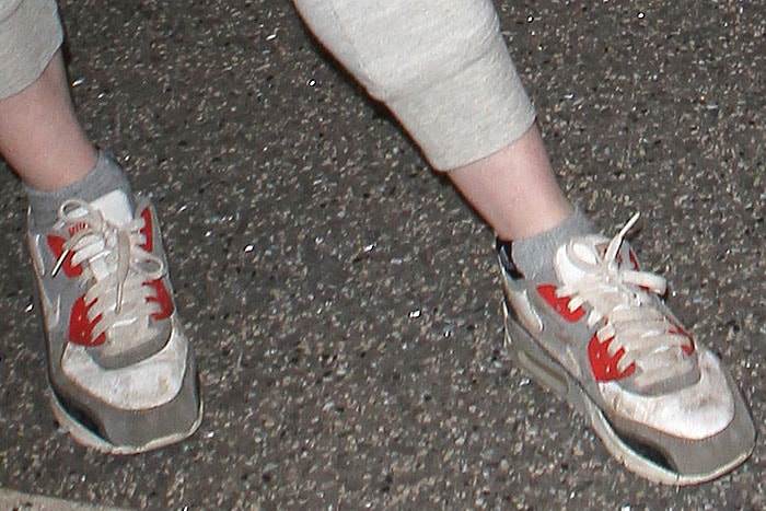 Rose Leslie completes her casual airport look with classic red and white Nike 'Air Max 90' sneakers