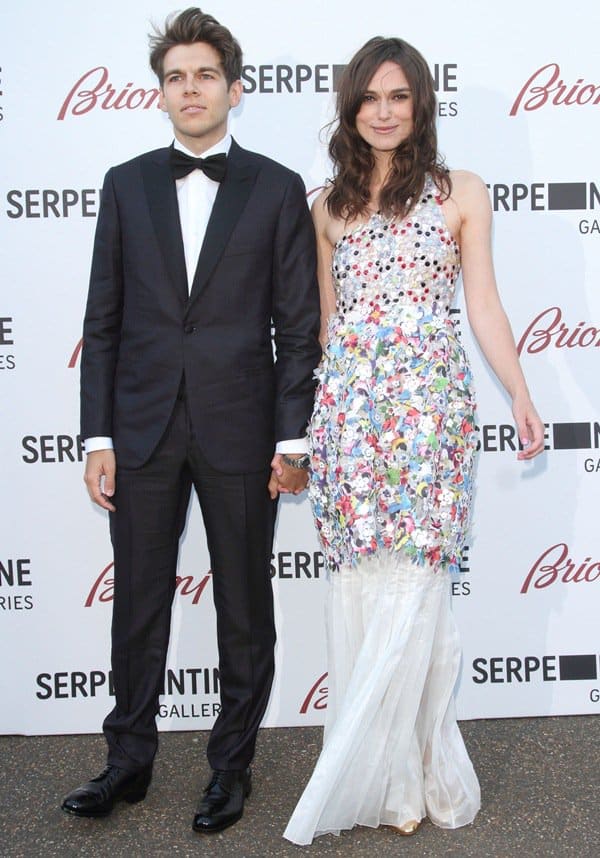 Keira Knightley stood out in a beaded Chanel gown with floral appliqués, subtly grounded by white peep-toe heels alongside husband James Righton