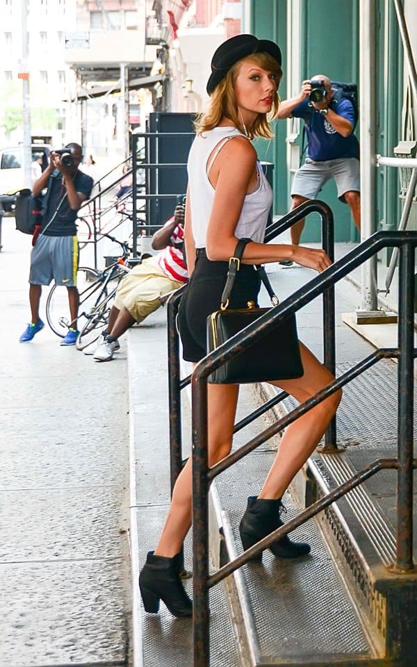 Taylor Swift accessorized her look with Rag Bone Miles boots and a black Free People Patton pork pie hat