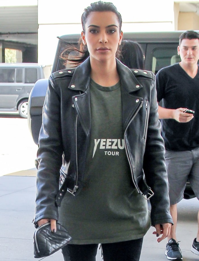 Kim Kardashian shops at Topanga Mall in Canoga Park on August 5, 2014, wearing a glazed BLK DNM leather jacket over an oversized Yeezus tour tee, blending edgy streetwear with designer flair