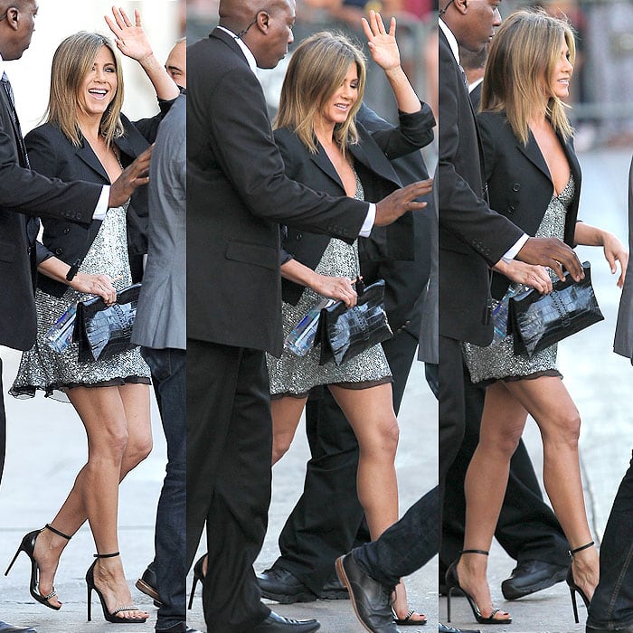 Jennifer Aniston exudes relaxed glamour in a shimmering Saint Laurent mini dress, a cropped black blazer, and sleek chain-detail sandals, before heading to the Life of Crime premiere in Hollywood