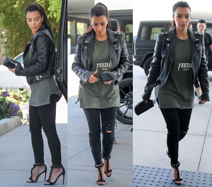 Kim Kardashian elevates her edgy streetwear look with Alaïa’s black suede studded T-strap heels, adding height and polish to her oversized Yeezus tee and leather jacket ensemble