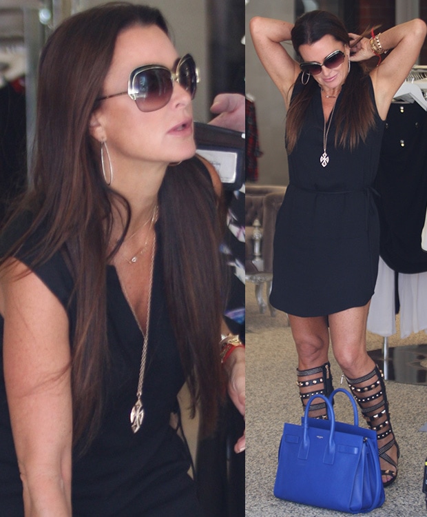 Kyle Richards steps out in a sleeveless black dress and statement Ivy Kirzhner gladiator sandals, accessorized with oversized sunglasses and a bold cobalt blue Birkin bag