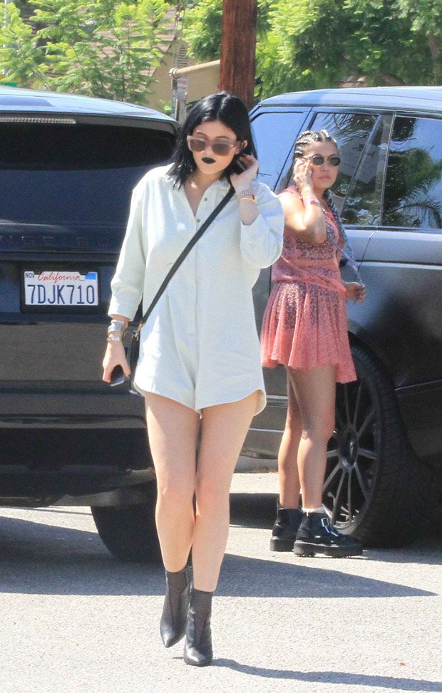 Kylie Jenner steps out in West Hollywood wearing a collared romper that gives the illusion of not wearing pants, paired with stylish black ankle boots