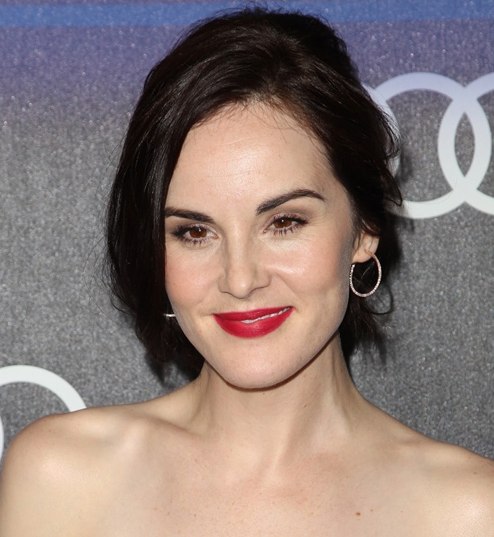 Michelle Dockery with messy hair and a splash of red lipstick