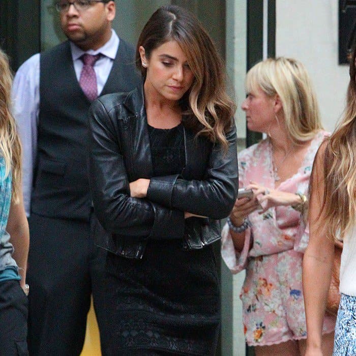 Nikki Reed steps through SoHo in a fitted black dress and leather jacket, letting sleek textures and confident posture define the look