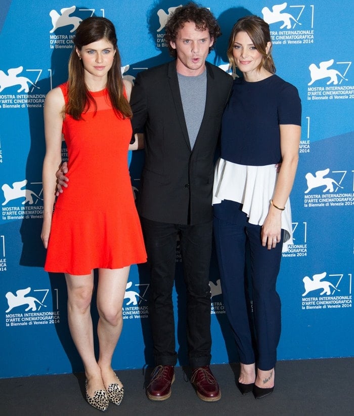 Alexandra Daddario, Anton Yelchin, and Ashley Greene pose together at the festival’s photo call, blending bold color, relaxed tailoring, and timeless black pumps
