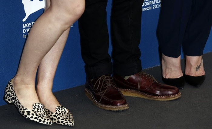 A detail shot reveals each actor’s shoe choice—Daddario’s leopard loafers, Yelchin’s burgundy derbies, and Greene’s classic black Louboutin So Kate pumps
