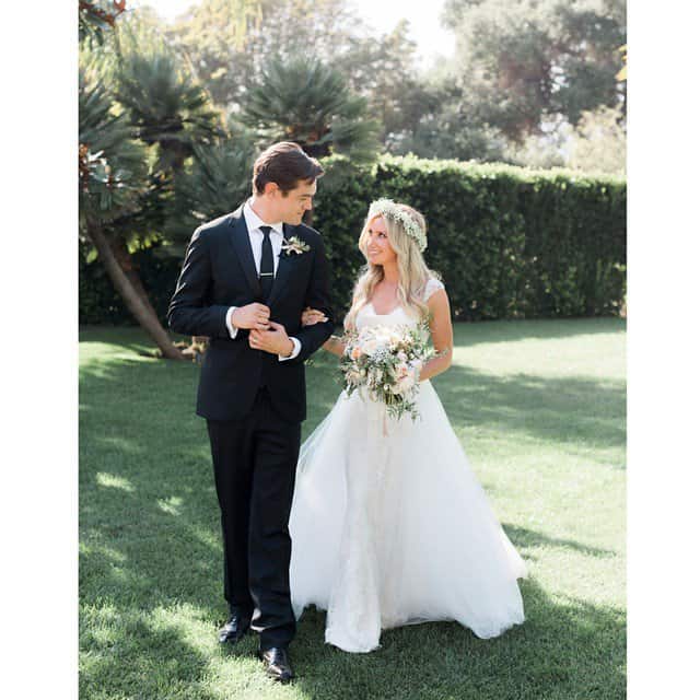 Ashley stunned everyone by choosing a traditionally styled gown with cap sleeves and a voluminous ball skirt, perfectly complemented by a baby's breath flower wreath in her loose waves