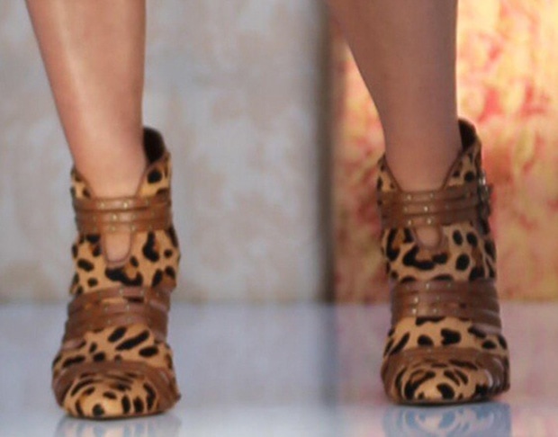 Jessica Simpson steps out in her bold and fierce leopard-print "Carlin" pump booties, featuring cutout details, studded straps, and a pointed-toe silhouette from her collection