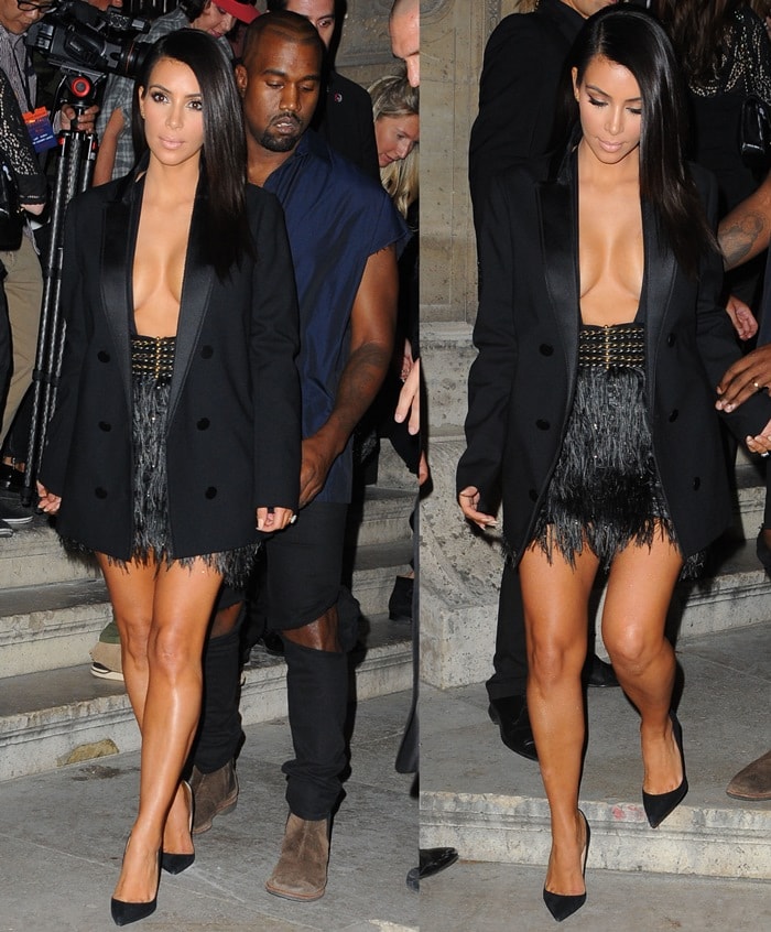 Kim Kardashian leaves the Lanvin Spring/Summer 2015 show in Paris wearing a feather-fringe Lanvin miniskirt and oversized black blazer, finishing the daring look with sleek black suede Jimmy Choo “Anouk” pumps