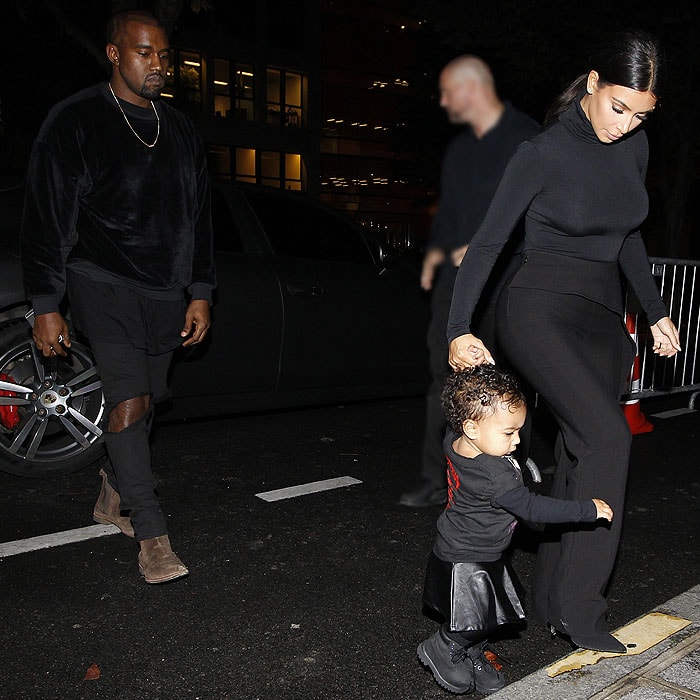 Kanye West and Kim Kardashian with North West heading to the Balenciaga runway show