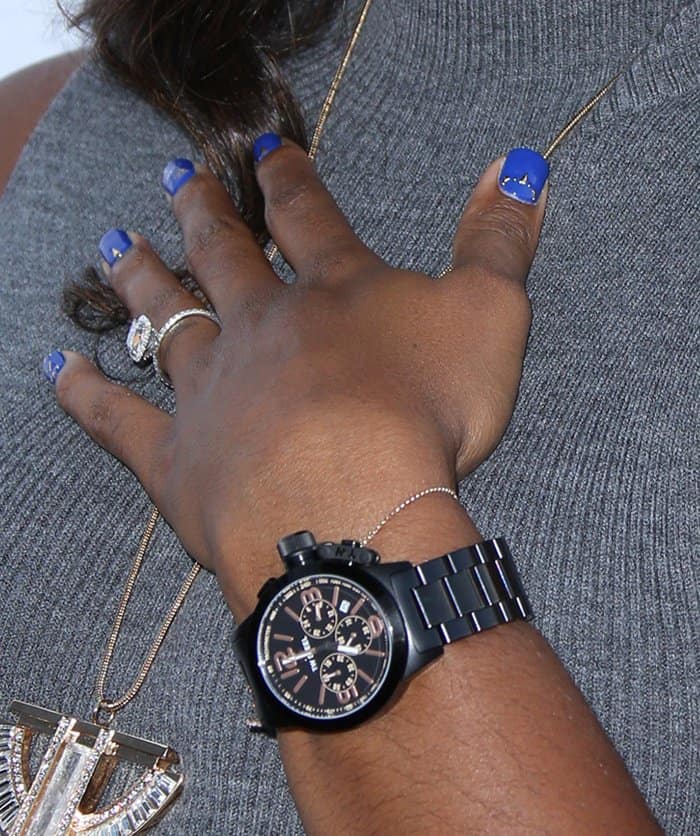 Kelly Rowland’s cobalt blue manicure pops against a matte black TW Steel chronograph, while delicate rings and a fine bracelet soften the oversized timepiece