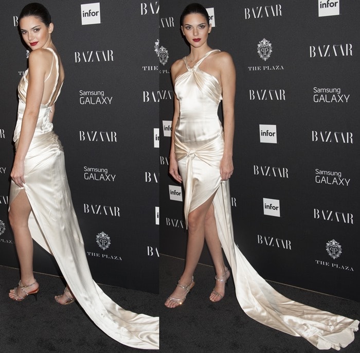 The rising model stuns in a draped Octavio Carlin gown with a knotted sash and sweeping train, complemented by sparkling silver sandals