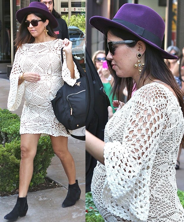 Kourtney Kardashian exuded boho-chic vibes while leaving the American Girl store at The Grove in Los Angeles on September 14, 2014, wearing a cream crochet dress, a statement HM plum wool hat, black suede ankle boots, and carrying a practical Prada baby bag