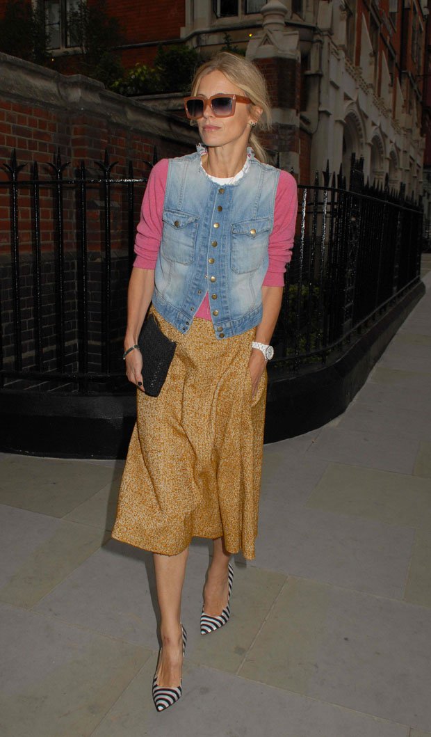Laura Bailey masters effortless layering in a denim vest over a sweater, pairing it with a flowing midi skirt and statement striped pumps outside the Chiltern Firehouse in London on July 25, 2014